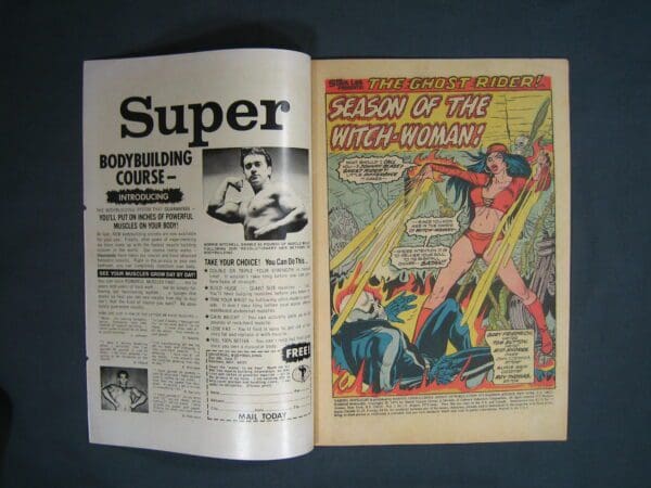 Sentence with product name: An open vintage comic book displaying an advertisement for a bodybuilding course on the left and a colorful comic page titled "Marvel Spotlight #11 - Season of the Witch-Woman!" on the right.