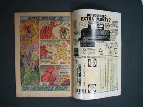 An open vintage comic book displaying a colorful page from Ghost Rider #9 series alongside an advertisement for extra money.