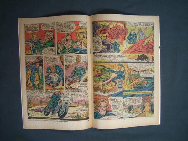 Opened Ghost Rider #12 comic book displaying colorful artwork and dialogue bubbles on two pages.