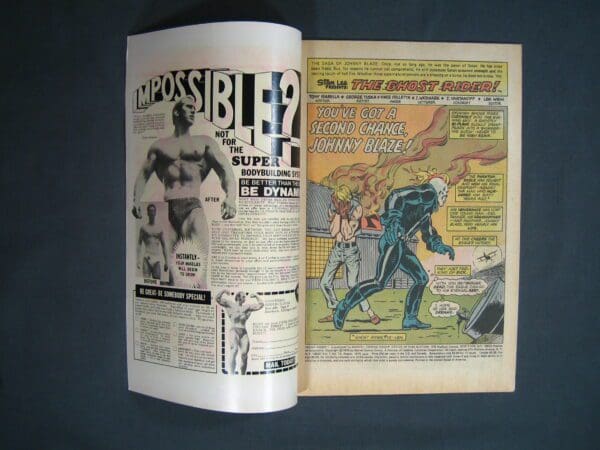 Open comic book displaying an advertisement and a page from Ghost Rider #13.