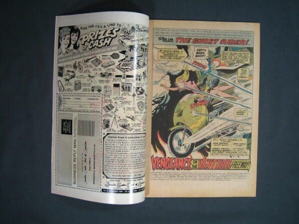 An open vintage comic book featuring an advertisement and the start of a Ghost Rider #15 story on a black background.